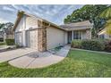 Charming home featuring a two-car garage, a well-manicured lawn, and clean, neutral siding at 6425 Thicket Trl, New Port Richey, FL 34653