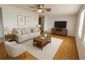 Bright living room boasts stylish furniture, neutral color palette, and tile flooring at 6450 Limerick Ave, New Port Richey, FL 34653
