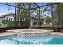 Close-up of the inviting hot tub and refreshing pool combo, perfect for relaxation and entertainment at 6490 Pine Meadows Dr, Spring Hill, FL 34606