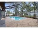 Relaxing screened-in pool area with spa offers a perfect outdoor retreat for leisure and entertainment at 6490 Pine Meadows Dr, Spring Hill, FL 34606