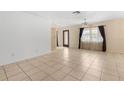 Bright living room featuring tile floors, large windows and neutral wall color at 7464 Acorn Cir, Spring Hill, FL 34606