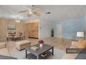 Bright and airy living room with tile floors, ceiling fan, and a dining area at 7464 Acorn Cir, Spring Hill, FL 34606