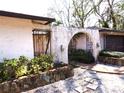 Gated courtyard entrance with decorative stonework and wrought iron, enhancing privacy and curb appeal at 7632 Lake Forest Cir, Port Richey, FL 34668