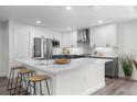 Modern kitchen features stainless steel appliances, white cabinets, and quartz countertops at 9482 Noddy Tern Rd, Weeki Wachee, FL 34613