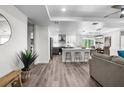 Bright open-concept living space with hardwood floors, modern lighting, and a kitchen island at 9482 Noddy Tern Rd, Weeki Wachee, FL 34613