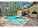 Inviting screened-in pool area with ample deck space, perfect for outdoor relaxation and entertainment at 9757 Hermosillo Dr, New Port Richey, FL 34655
