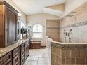 Luxurious bathroom with walk-in shower, dual shower heads, granite countertops, and ample cabinet space at 2255 Long View Cir, Brooksville, FL 34604