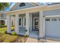 Inviting front porch with stately columns, offering a warm welcome to this delightful home at 11401 Quiet Forest Dr, Tampa, FL 33635