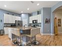 Modern kitchen with granite countertops, stainless steel appliances, and a spacious center island at 11401 Quiet Forest Dr, Tampa, FL 33635