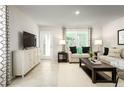 Inviting living room with neutral tones, stylish decor, and natural light creating a cozy and modern space at 11410 Spectacled Dr, New Port Richey, FL 34654