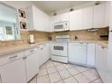 Efficient kitchen with white cabinets, modern appliances, and ample counter space at 11631 Bayonet Ln, New Port Richey, FL 34654