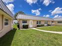 Charming single-story home with well-maintained lawn, white front door and neutral exterior color scheme at 11821 Boynton Ln, New Port Richey, FL 34654