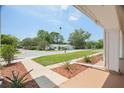 Inviting front yard view from the porch with lush greenery and street view at 12106 Bear Creek Ln, Hudson, FL 34667