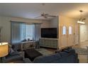 Comfortable living room with bright natural light, vaulted ceiling, ceiling fan, and views into the entry hallway at 1221 Etta Ave, Spring Hill, FL 34609