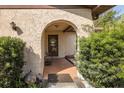 Welcoming arched front porch with cozy seating amidst lush greenery at 12250 Lacey Dr, New Port Richey, FL 34654