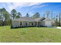 Well-maintained single-story home with manicured lawn, mature trees, and attached two-car garage at 13343 Sampson Ave, Brooksville, FL 34614