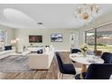 Bright, open-concept living room with sleek hardwood floors and lots of natural light at 1402 Tallahassee Dr, Tarpon Springs, FL 34689