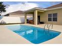 Backyard pool with a patio and white fence, perfect for outdoor relaxation and entertaining in a sunny setting at 15205 Durango Cir, Brooksville, FL 34604