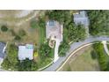 Expansive aerial view of a community with a beautiful pool and manicured landscaping surrounding the neighborhood at 18644 Autumn Lake Blvd, Hudson, FL 34667