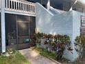 Building exterior showing unit entry with a screened-in porch and nicely landscaped sidewalk at 1983 Abrico Dr # H-9, Lutz, FL 33558