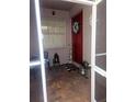Charming front porch with a bright red door, decorated with a floral wreath and 'Gather' sign at 20720 Eustis Rd, Land O Lakes, FL 34637