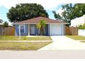 Attractive single-Gathering home with a driveway, garage, palm tree, and well-kept lawn at 3315 W Saint John St, Tampa, FL 33607