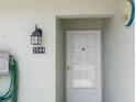 Close-up of front door, displaying house number and outdoor lighting fixture at 3544 Teeside Dr # 1, New Port Richey, FL 34655