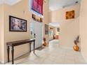 Bright foyer with tile floors, high ceilings, and decorative art, creating a welcoming entrance at 4148 Landover Blvd, Spring Hill, FL 34609