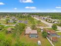 Expansive aerial view of a home featuring a private pool, spacious yard, and convenient access to nearby shops and restaurants at 4190 Lema Dr, Spring Hill, FL 34609