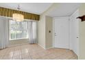 Bright entryway featuring tile flooring, a chandelier, and a storm door at 4837 Boonesboro Ct, New Port Richey, FL 34655