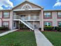 Charming two-story condo exterior featuring well-maintained landscaping and a welcoming entrance at 4903 Myrtle Oak Dr # 12, New Port Richey, FL 34653