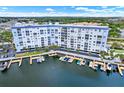 Stunning aerial view of waterfront condo building, showcasing its boat docks, lush landscaping, and convenient access to coastal living at 4939 Floramar Ter # 204, New Port Richey, FL 34652