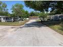 Street view of the neighborhood with a mix of single-Gathering homes at 5023 Queen Palm Dr, New Port Richey, FL 34652