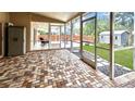 Spacious screened-in patio with a brick paver floor, providing an ideal space for outdoor relaxation and entertainment at 5152 Panther Dr, Spring Hill, FL 34607