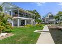 Waterfront home featuring lush landscaping, covered patios, and private dock access with waterfront views at 5234 Foxhall Ct, Weeki Wachee, FL 34607