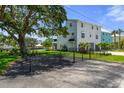 Exterior view featuring a fenced yard, a multi car garage, and well-maintained landscaping at 5234 Foxhall Ct, Weeki Wachee, FL 34607