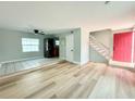 Spacious living room with tile and wood flooring and a bright red front door at 5713 Townhouse Dr # 5713, New Port Richey, FL 34652