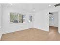 Well-lit room with white walls, hardwood floors, and natural light from windows at 5753 2Nd N Ave, St Petersburg, FL 33710