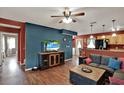 Cozy living room featuring an open floorplan, wood-look floors, and modern decor at 7089 Goodway, Brooksville, FL 34602