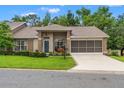 Inviting home with well-manicured lawn, screened garage and a welcoming front entrance at 7367 Willow Brook Dr, Spring Hill, FL 34606