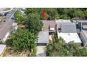 A stunning aerial view highlighting the property's roof, landscaping, and proximity to neighboring homes at 7501 Woodbox Row, Hudson, FL 34667