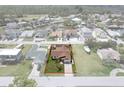 Aerial view of home in a waterfront community featuring a spacious yard outlined in red at 7520 Mako Dr, Hudson, FL 34667