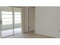 Bedroom with sliding glass door, neutral carpet, and light walls, offering a bright and versatile space at 7600 St. Andrews Blvd # 7600, Weeki Wachee, FL 34613