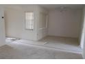 Bright living room with neutral carpet, ample windows, and a ceiling fan, creating a comfortable living space at 7600 St. Andrews Blvd # 7600, Weeki Wachee, FL 34613