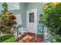 Inviting front porch with seating and vibrant landscaping, creating a warm welcome to the home at 8021 Wildflower Row, Hudson, FL 34667