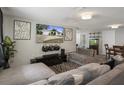 Cozy living room with large sectional sofa, mounted TV, and modern decor at 9111 Greenbriar Ln, Port Richey, FL 34668