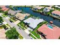 Aerial view of the home showcasing its location along the canal waterfront in a coastal community at 9810 Compass Point Way, Tampa, FL 33615