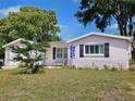 Charming one-story home boasts a vibrant yard, mature trees, and painted exterior accents at 6339 Delaware Ave, New Port Richey, FL 34653