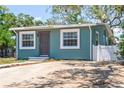 Home featuring a well-maintained lawn, new driveway, and inviting curb appeal at 1000 Magnolia Dr, Clearwater, FL 33756
