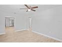 Spacious living room featuring neutral walls, light hardwood floors, and a ceiling fan at 1000 Magnolia Dr, Clearwater, FL 33756